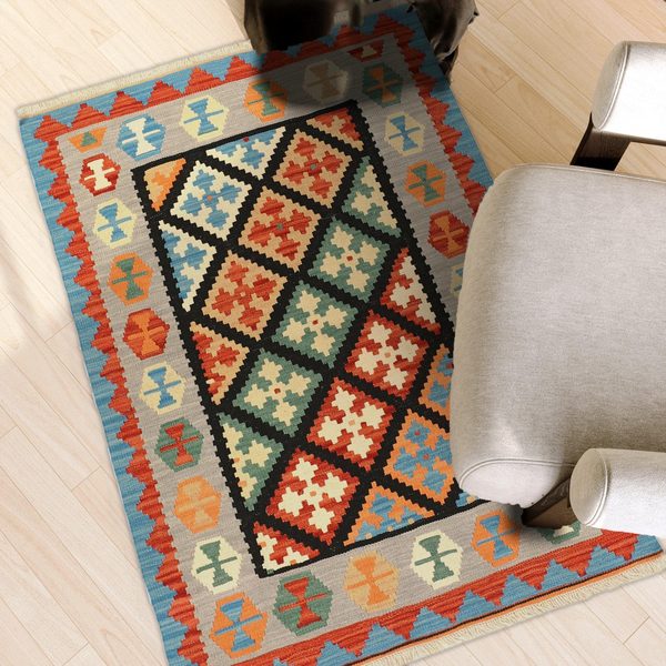 Kilim Rug in Black and Green in a light living room, true size