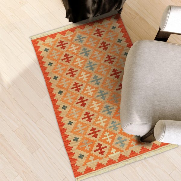 Small Kilim Rug in Orange and Beige in a light living room, true size